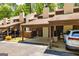 View of the exterior of the townhouses with covered parking on a sunny day at 65 Cobblestone Crk, Peachtree City, GA 30269