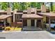 Charming townhouse exterior featuring a covered parking area and well-maintained landscaping at 65 Cobblestone Crk, Peachtree City, GA 30269