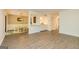 Open concept living and dining area with wood-look floors, modern lighting, and a decorative wreath at 65 Cobblestone Crk, Peachtree City, GA 30269