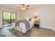 Bright main bedroom with a private balcony, ceiling fan, ensuite and hardwood flooring throughout at 65 Cobblestone Crk, Peachtree City, GA 30269