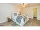 Spacious main bedroom featuring hardwood flooring, ceiling fan, neutral walls, and a cozy rug at 65 Cobblestone Crk, Peachtree City, GA 30269