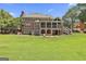 Expansive brick home with a screened porch and sprawling green lawn at 106 Hidden Springs Ln, Peachtree City, GA 30269