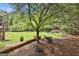 Expansive backyard featuring mature trees, lush lawn, and impeccable landscaping at 106 Hidden Springs Ln, Peachtree City, GA 30269