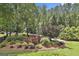 Lush backyard with vibrant flower beds and manicured landscaping creates a serene outdoor oasis at 106 Hidden Springs Ln, Peachtree City, GA 30269
