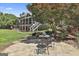 Charming backyard with a stone patio and seating area nestled among trees at 106 Hidden Springs Ln, Peachtree City, GA 30269