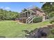 Beautifully landscaped backyard with screened porch and lush lawn at 106 Hidden Springs Ln, Peachtree City, GA 30269