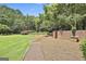 Picturesque backyard with mature landscaping and beautiful trees at 106 Hidden Springs Ln, Peachtree City, GA 30269