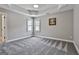 An unfurnished bedroom with gray carpet, neutral walls, a trey ceiling, and natural lighting at 106 Hidden Springs Ln, Peachtree City, GA 30269