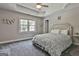 A neutral-colored bedroom features a trey ceiling, large window, soft carpet and a statement headboard at 106 Hidden Springs Ln, Peachtree City, GA 30269