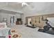 Large bonus room area with wood wall accents, Peloton, exercise equipment, and adjacent living space at 106 Hidden Springs Ln, Peachtree City, GA 30269