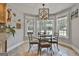 Cozy breakfast nook with a glass table, seating for four and views of the well manicured backyard through three large windows at 106 Hidden Springs Ln, Peachtree City, GA 30269