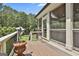 Decking area shows a screened porch structure, wooded backyard, and potted plants at 106 Hidden Springs Ln, Peachtree City, GA 30269