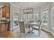 Cozy breakfast nook with a modern light fixture and lots of natural light from surrounding windows at 106 Hidden Springs Ln, Peachtree City, GA 30269