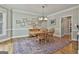 Dining room featuring hardwood floors, traditional wooden furniture, decorative lighting, and neutral wall colors at 106 Hidden Springs Ln, Peachtree City, GA 30269