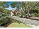 Elegant brick home with a circular driveway, lush landscaping, and a serene setting at 106 Hidden Springs Ln, Peachtree City, GA 30269