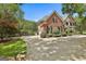 Well-maintained brick home with an expansive driveway and meticulously landscaped grounds at 106 Hidden Springs Ln, Peachtree City, GA 30269