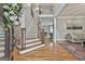 Grand foyer with hardwood floors, staircase, and an open view into the living spaces at 106 Hidden Springs Ln, Peachtree City, GA 30269