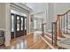 Welcoming foyer boasts hardwood floors, a decorative front door with leaded glass, and a staircase with iron balusters at 106 Hidden Springs Ln, Peachtree City, GA 30269