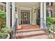 Elegant front entrance with brick steps, decorative door, and classic columns at 106 Hidden Springs Ln, Peachtree City, GA 30269