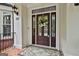 Stylish front door with decorative glass, brick porch, and a welcoming entrance mat at 106 Hidden Springs Ln, Peachtree City, GA 30269