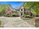 Charming brick home with a circular driveway, beautiful landscaping, and classic curb appeal at 106 Hidden Springs Ln, Peachtree City, GA 30269