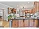 Large kitchen island with granite counters, stainless appliances and dark wood cabinetry at 106 Hidden Springs Ln, Peachtree City, GA 30269