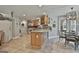Open kitchen with a large island, stainless steel appliances, and an adjacent dining area at 106 Hidden Springs Ln, Peachtree City, GA 30269