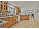 Open kitchen with granite countertops, wood cabinets, and a view into the living room at 106 Hidden Springs Ln, Peachtree City, GA 30269