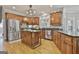Spacious kitchen features wood cabinetry, granite counters, and stainless-steel appliances at 106 Hidden Springs Ln, Peachtree City, GA 30269