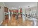 Open eat-in kitchen with wood cabinets, stainless appliances, a kitchen island, and hardwood flooring at 106 Hidden Springs Ln, Peachtree City, GA 30269