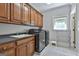 Spacious laundry room with lots of cabinets, sink, modern washer and dryer and tiled floors at 106 Hidden Springs Ln, Peachtree City, GA 30269