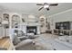 Spacious living room with a fireplace, custom shelves, and ample seating, perfect for entertaining guests at 106 Hidden Springs Ln, Peachtree City, GA 30269