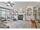 Inviting living room with a fireplace, custom built-ins, hardwood floors, and plenty of natural light at 106 Hidden Springs Ln, Peachtree City, GA 30269