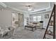 Upstairs living room has a trey ceiling, barn door and a comfortable couch to relax and watch TV at 106 Hidden Springs Ln, Peachtree City, GA 30269