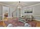 Comfortable living area with hardwood floors, a patterned rug, a view of the staircase, and an open doorway at 106 Hidden Springs Ln, Peachtree City, GA 30269