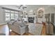 Inviting living room featuring hardwood floors, neutral paint, a fireplace, and built-in shelving at 106 Hidden Springs Ln, Peachtree City, GA 30269