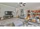 Comfortable living room area with hardwood floors, neutral paint, and access to the kitchen and stairs at 106 Hidden Springs Ln, Peachtree City, GA 30269