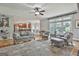 Bright, open living room with hardwood floors, large windows, and an open floor plan to the kitchen at 106 Hidden Springs Ln, Peachtree City, GA 30269