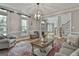 Bright and open living room with hardwood floors, neutral walls, large windows, and comfortable seating at 106 Hidden Springs Ln, Peachtree City, GA 30269