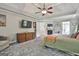 Main bedroom featuring a trey ceiling, ceiling fan, fireplace and adjoining bath at 106 Hidden Springs Ln, Peachtree City, GA 30269