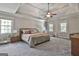 Spacious main bedroom with many windows, a ceiling fan, and a trey ceiling at 106 Hidden Springs Ln, Peachtree City, GA 30269