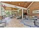 Inviting covered patio with brick walls, wood ceilings, and comfortable seating areas for relaxing or entertaining at 106 Hidden Springs Ln, Peachtree City, GA 30269