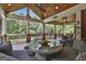 Expansive screened porch featuring a wood ceiling, wicker seating, and tranquil views of the lush backyard at 106 Hidden Springs Ln, Peachtree City, GA 30269
