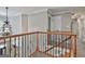 Stairway in the home with hardwood and carpeted steps, plus decorative wooden railing at 106 Hidden Springs Ln, Peachtree City, GA 30269