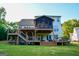 Expansive home backyard with a tiered wooden deck and screened-in porch perfect for outdoor entertaining at 155 Cottage Cir, Fayetteville, GA 30215