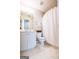 Simple bathroom featuring a vanity, toilet, shower with white curtain, and patterned linoleum flooring at 155 Cottage Cir, Fayetteville, GA 30215