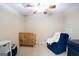 Bedroom featuring a ceiling fan, a cozy rocking chair and crib at 155 Cottage Cir, Fayetteville, GA 30215