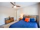 Cozy bedroom with wood furniture, carpet, and bed with blue comforter and decorative pillows at 155 Cottage Cir, Fayetteville, GA 30215