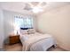 Charming bedroom with neutral tones, bright natural light, ceiling fan and a comfortable bed with soft bedding at 155 Cottage Cir, Fayetteville, GA 30215