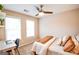 Bright bedroom featuring a bed, desk, large windows, and modern ceiling fan at 155 Cottage Cir, Fayetteville, GA 30215